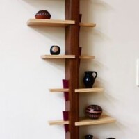 The Echols wall shelf. Exacting joinery with relaxed, flowing lines. Shelf edges evoke an "X" as well as that of a leaning hourglass.